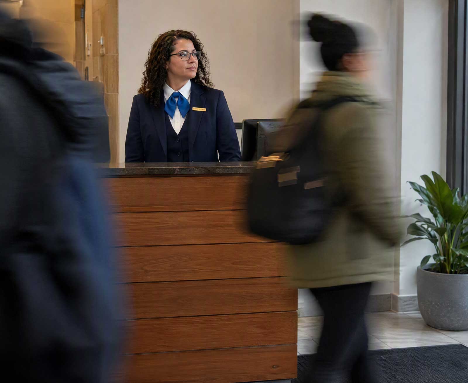 CITIPRO concierge security officer monitoring guests from a front desk