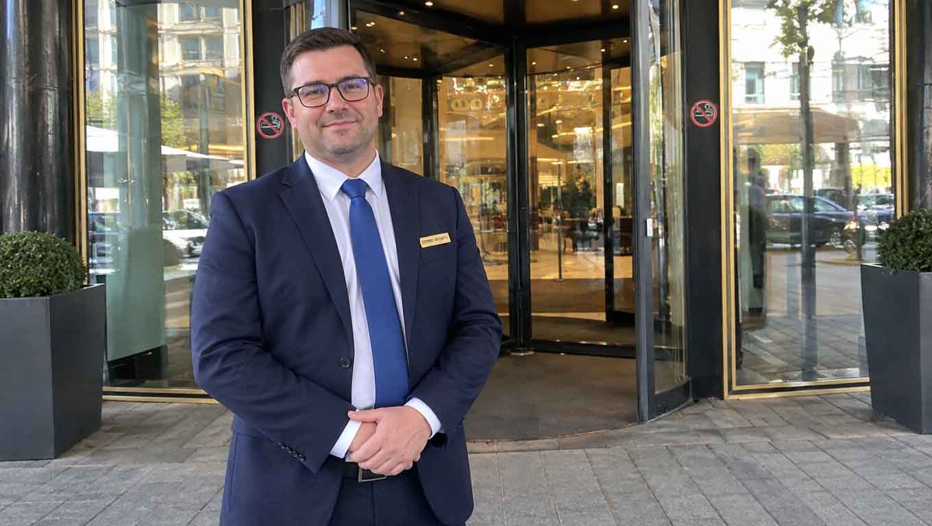 Hotel security professional in a suit outside the entrance